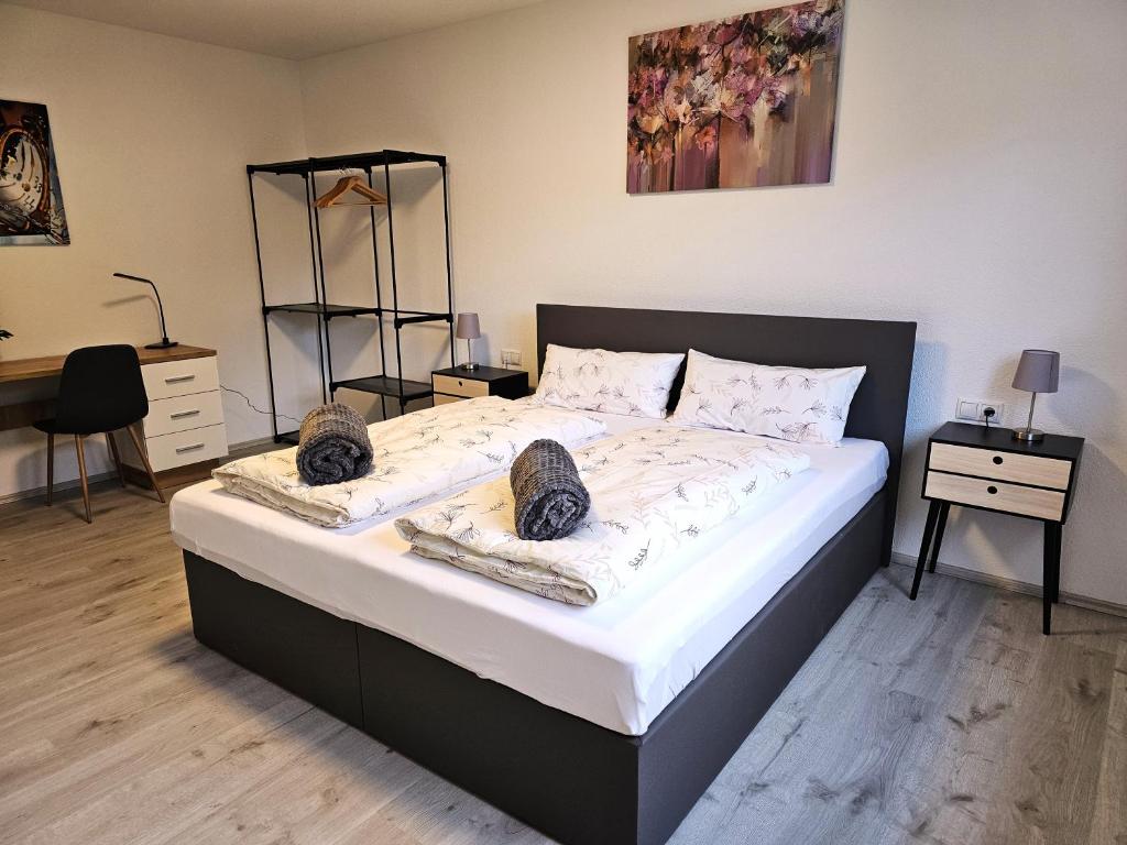 a bedroom with a large bed with two pillows at MY HOME AM HEUBERG Nr 4 in Frittlingen