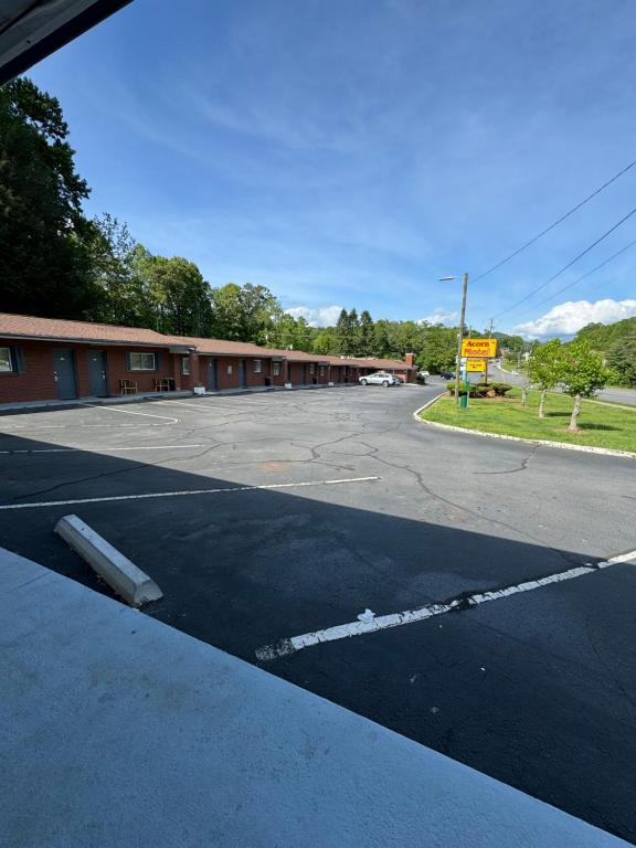 an empty parking lot in front of a building at Acorn Motel in Black Mountain