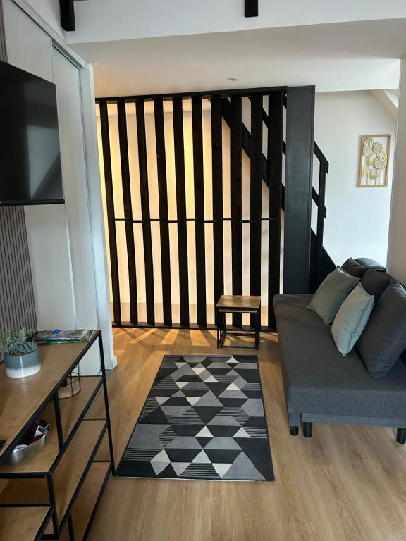 a living room with a couch and a table at Le repos de la Meuse in Givet