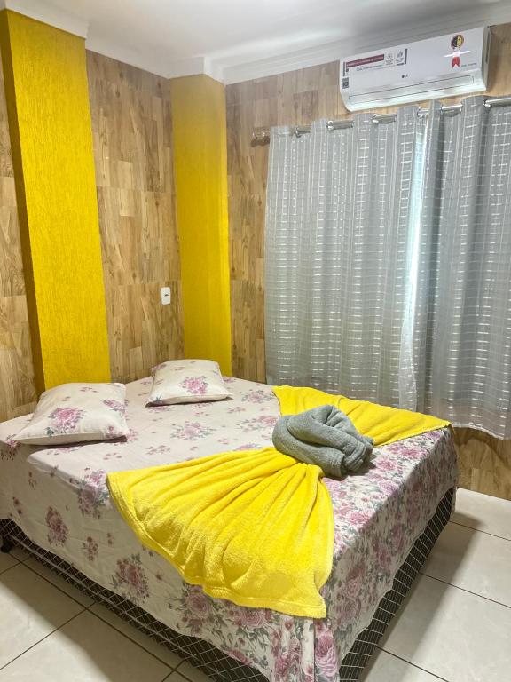 Postel nebo postele na pokoji v ubytování AP inteiro com ar condicionado