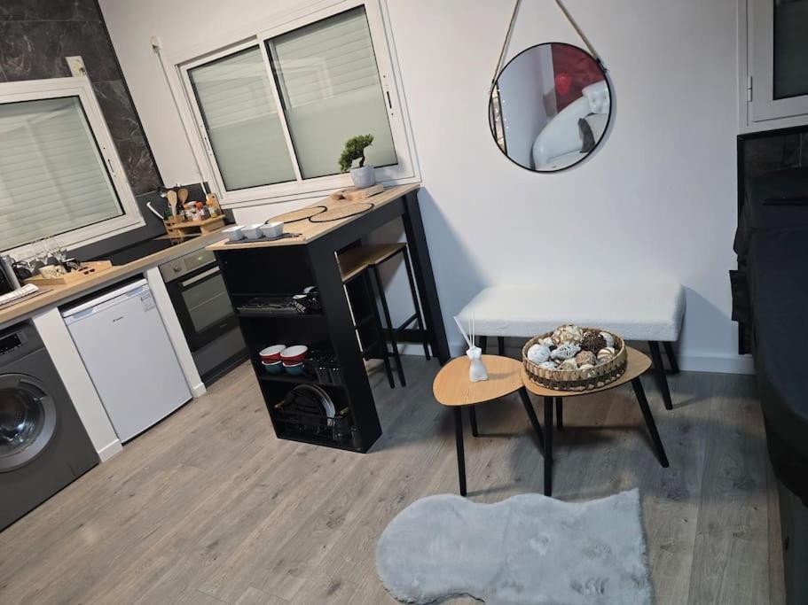 a living room with a table and a mirror at Logement Romantique Jacuzzi spa in Vieille-Toulouse