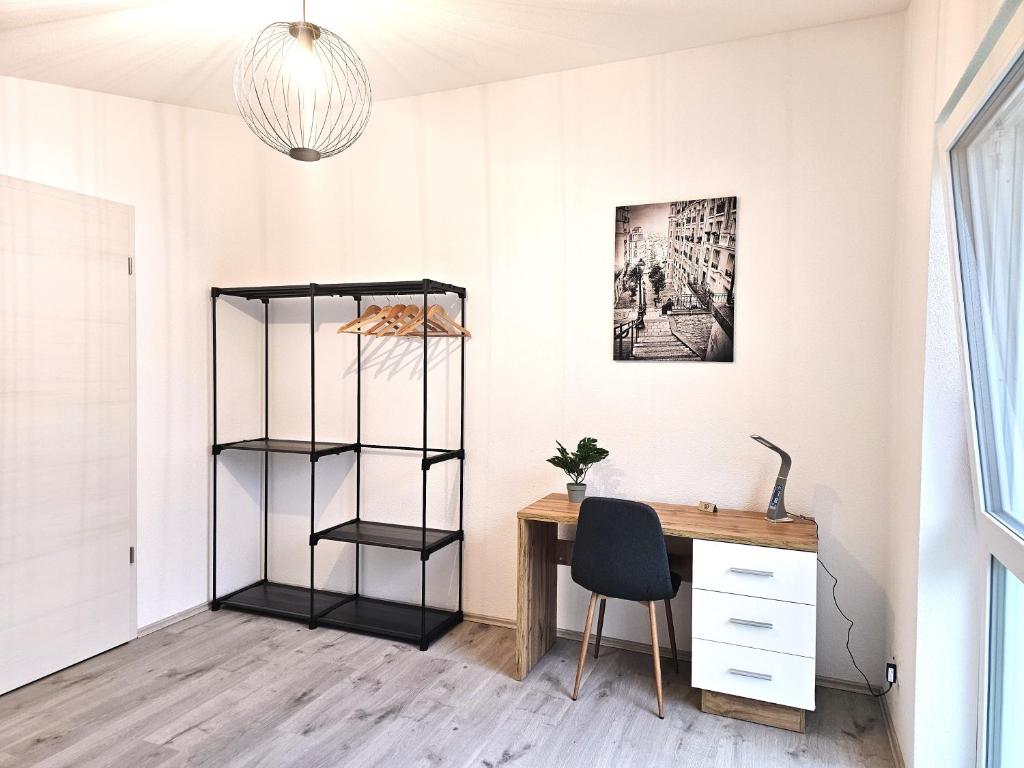 an office with a desk and a chair next to a shelf at MY HOME AM HEUBERG Nr 6 in Frittlingen