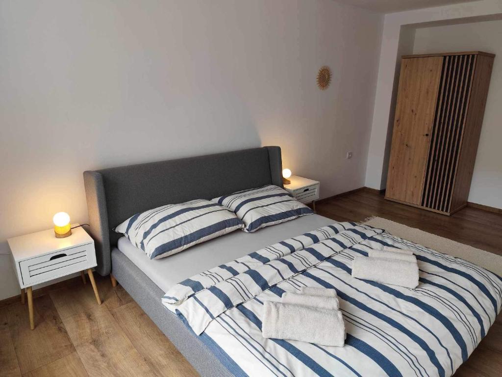 a bedroom with a bed with two pillows on it at Centrum Poprad Apartment in Poprad