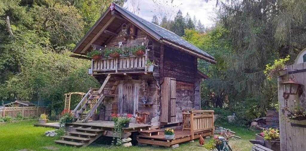 mała chata z bali z gankiem i kwiatami w obiekcie Amour & Chocolat w mieście Sixt