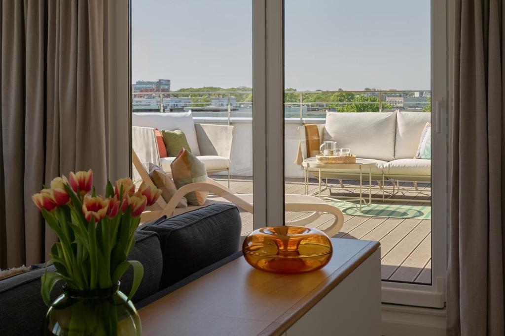 a living room with a view of a balcony at Apartament z tarasem Panorama in Kołobrzeg
