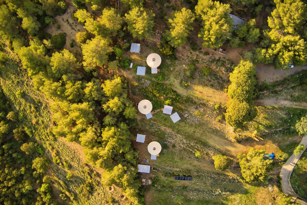 an overhead view of a yard with trees and buildings at La Muntanera - Eco Yurt - Pool, Nature retreat in Figuerola