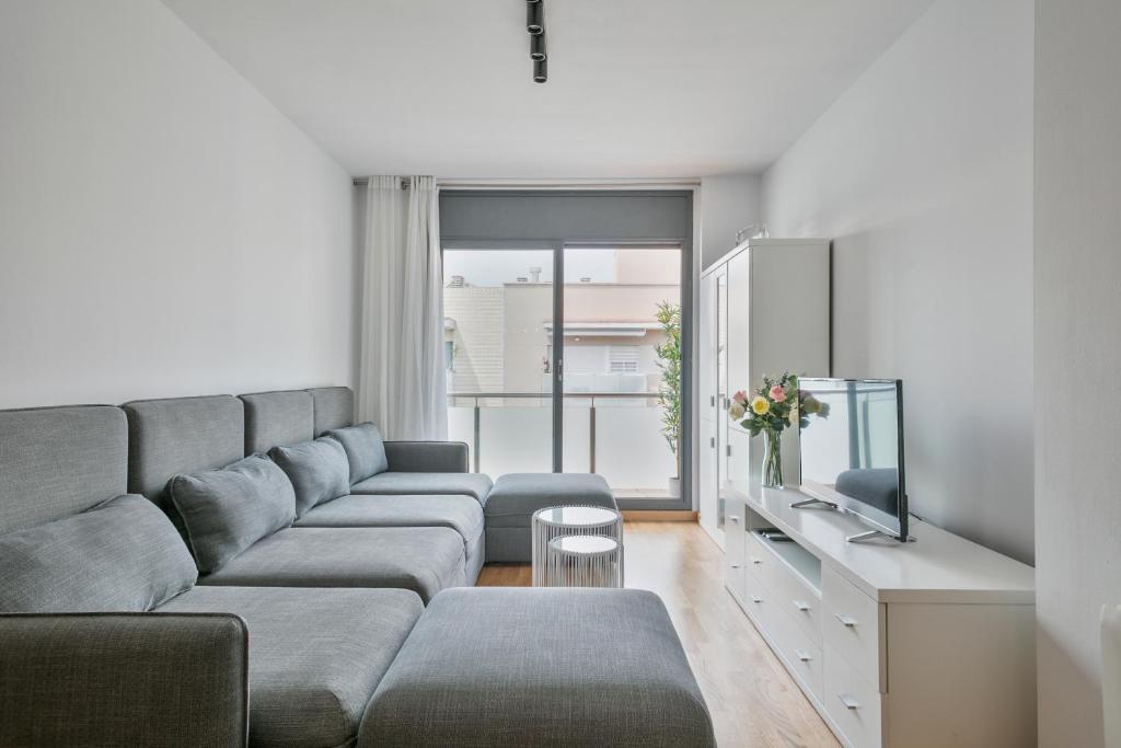 a living room with a couch and a tv at Apartment Pere IV in Barcelona