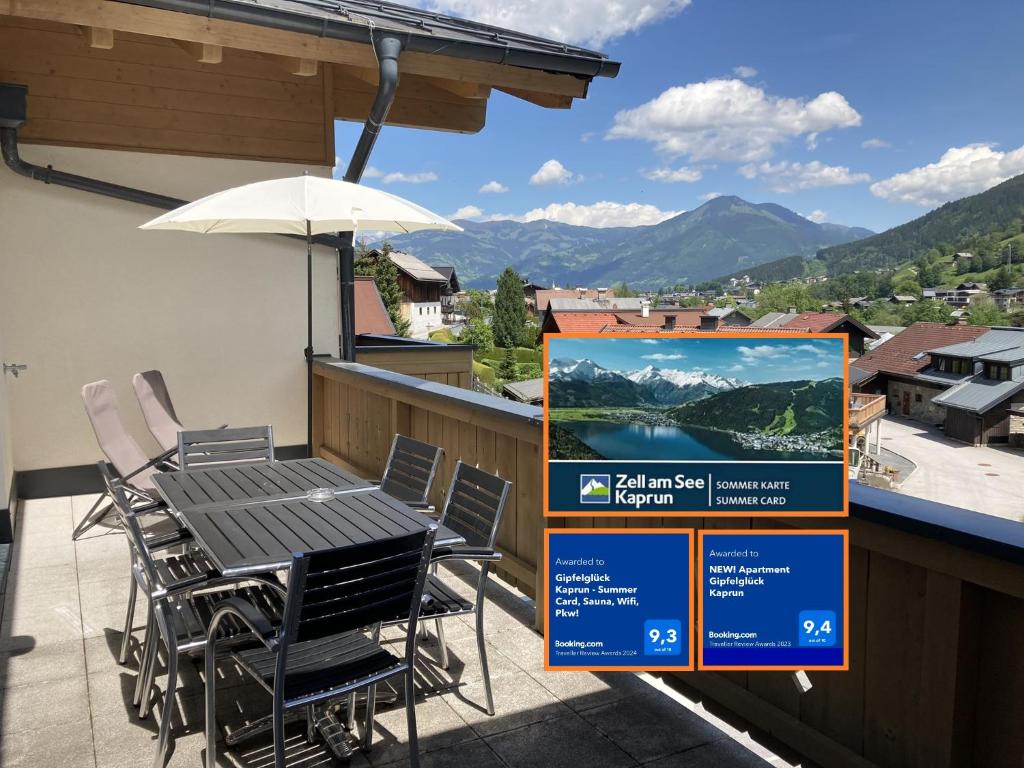 a table and chairs on a balcony with a view at Gipfelglück Kaprun - Summer Card, Sauna, Wifi, Pkw! in Kaprun