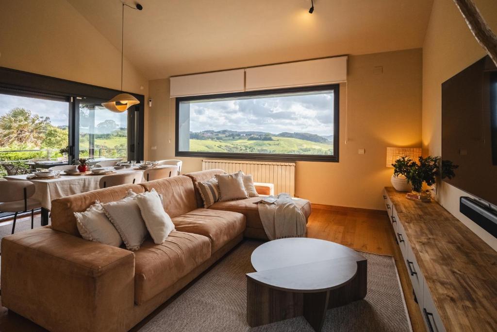 a living room with a couch and a table at Casa Buena Vista in Candás
