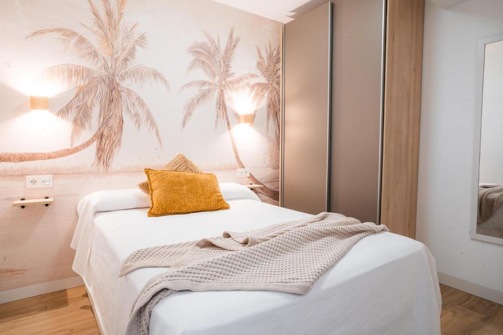 a bedroom with a white bed with a yellow pillow at Apartamento Boutique Beluga in Garrucha