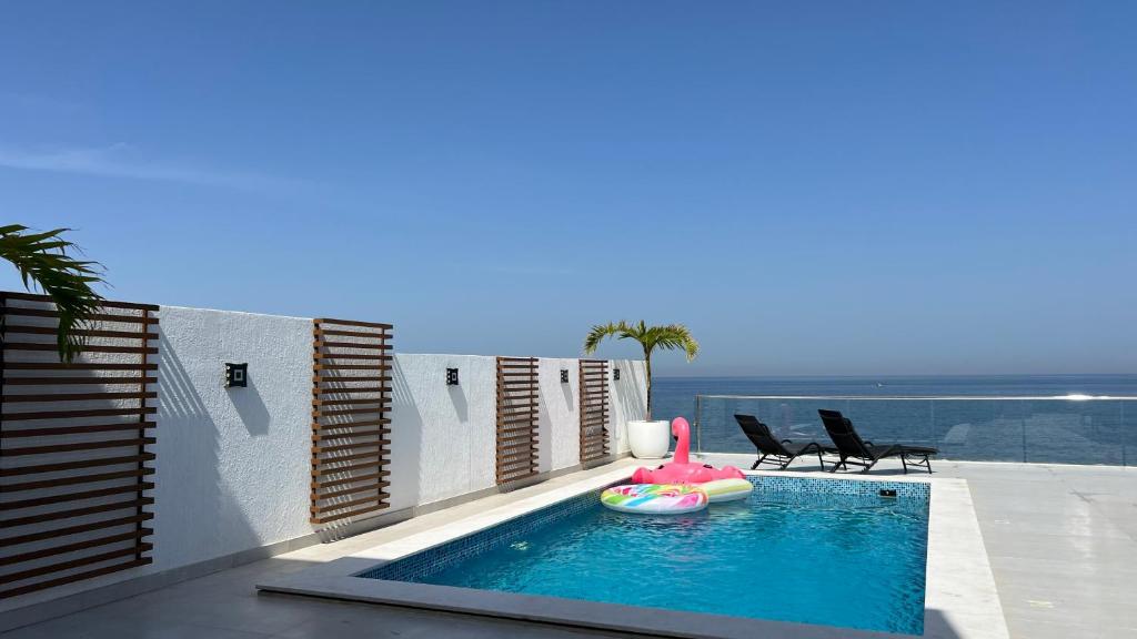 a swimming pool with a toy in the middle of a house at Seascape Villa in Fujairah