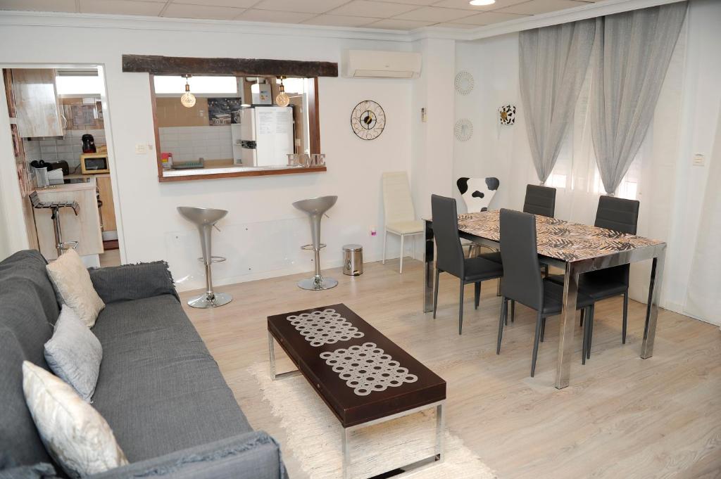 a living room with a table and a couch at La coqueta in Murcia