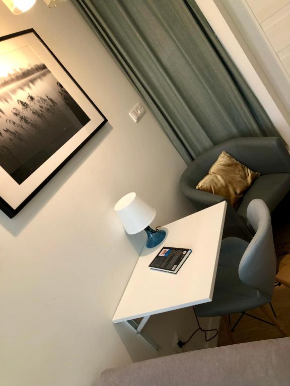 a living room with a table and a chair at CitizenA Studio no smoking in Radom