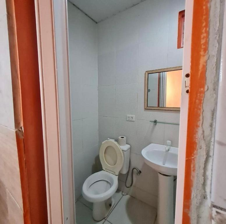 a small bathroom with a toilet and a sink at Pousada pirata in Recife