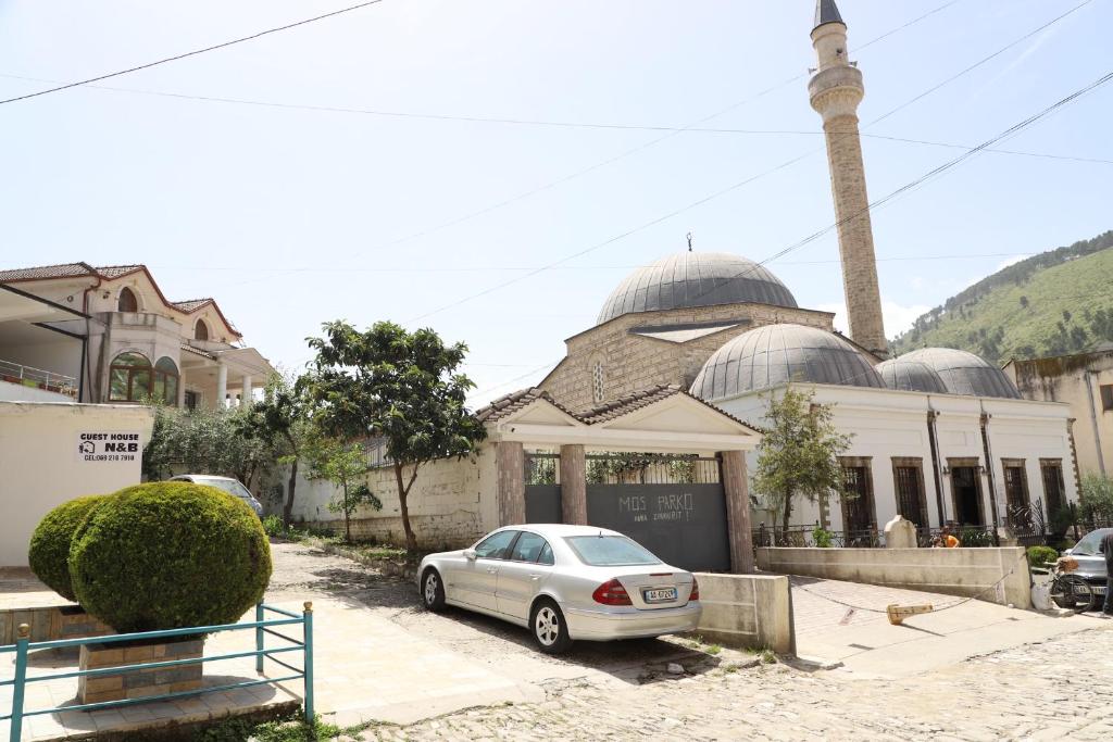 a mosque with a car parked in front of it at Guesthouse N&B in Berat