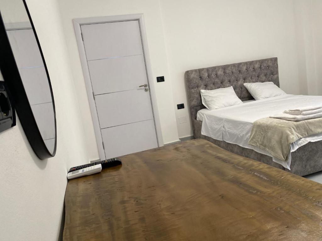 a bedroom with a bed and a mirror at Casa Del Sol Pogradec in Pogradec