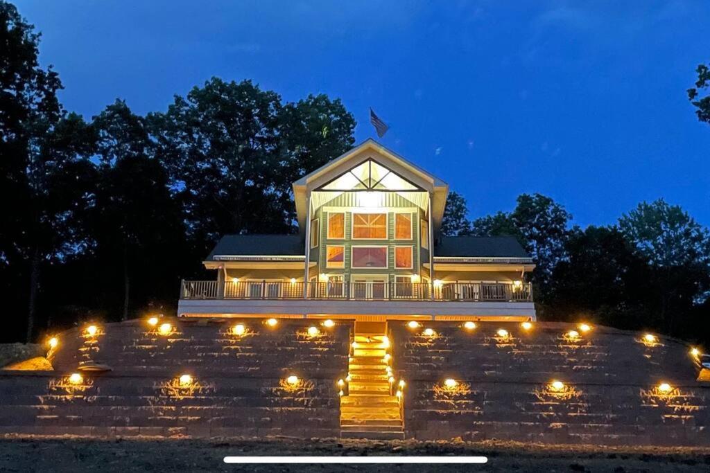 a building with lights in front of it at night at Luxury Mountain Home in Huntingdon
