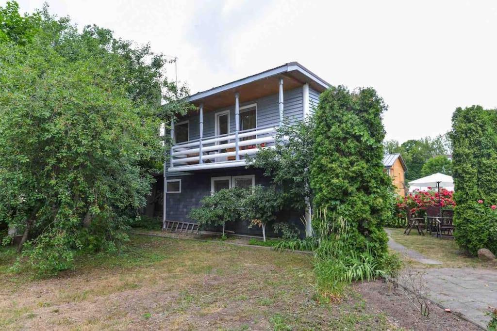 a large house with trees in front of it at Perfectly located summerhouse in Druskininkai