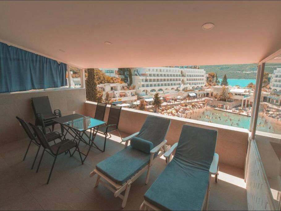 a balcony with chairs and tables and a view of a beach at Riba Fish Neum in Neum