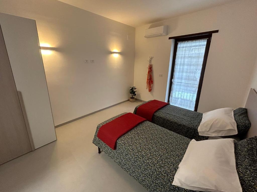 a living room with a couch and a window at Lettera 22 Apartment in Brindisi
