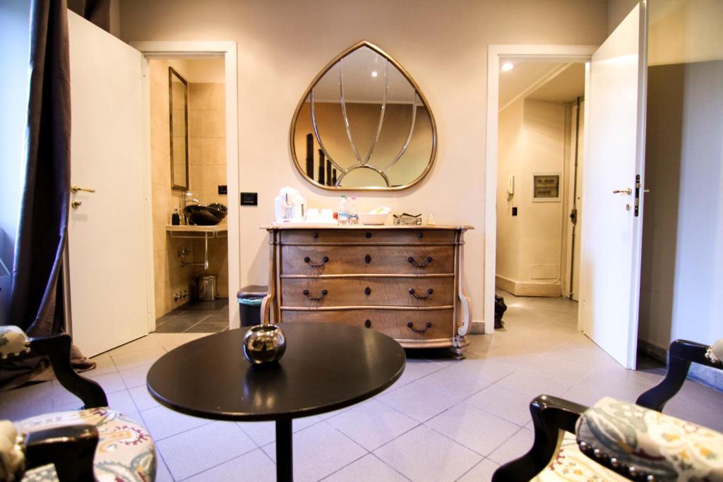 a bathroom with a table and a dresser with a mirror at Appartamento Mellini in Rome