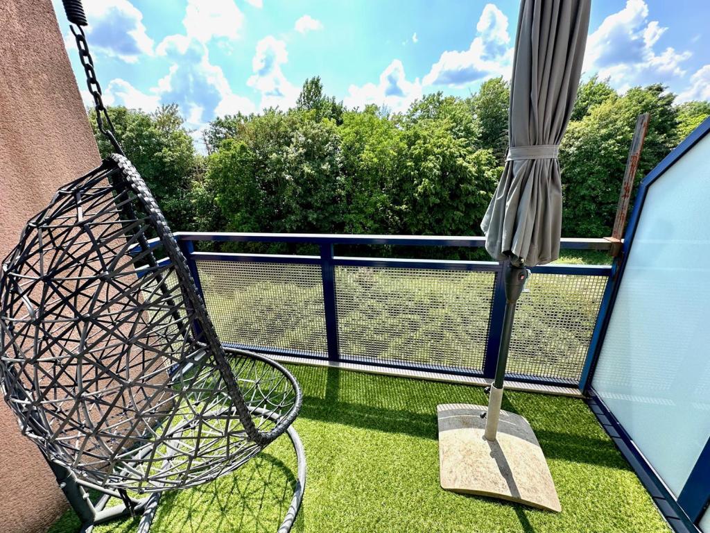 a balcony with an umbrella and a swing at Charming Apartement Luxembourg City Center, Parking, Balcony in Luxembourg