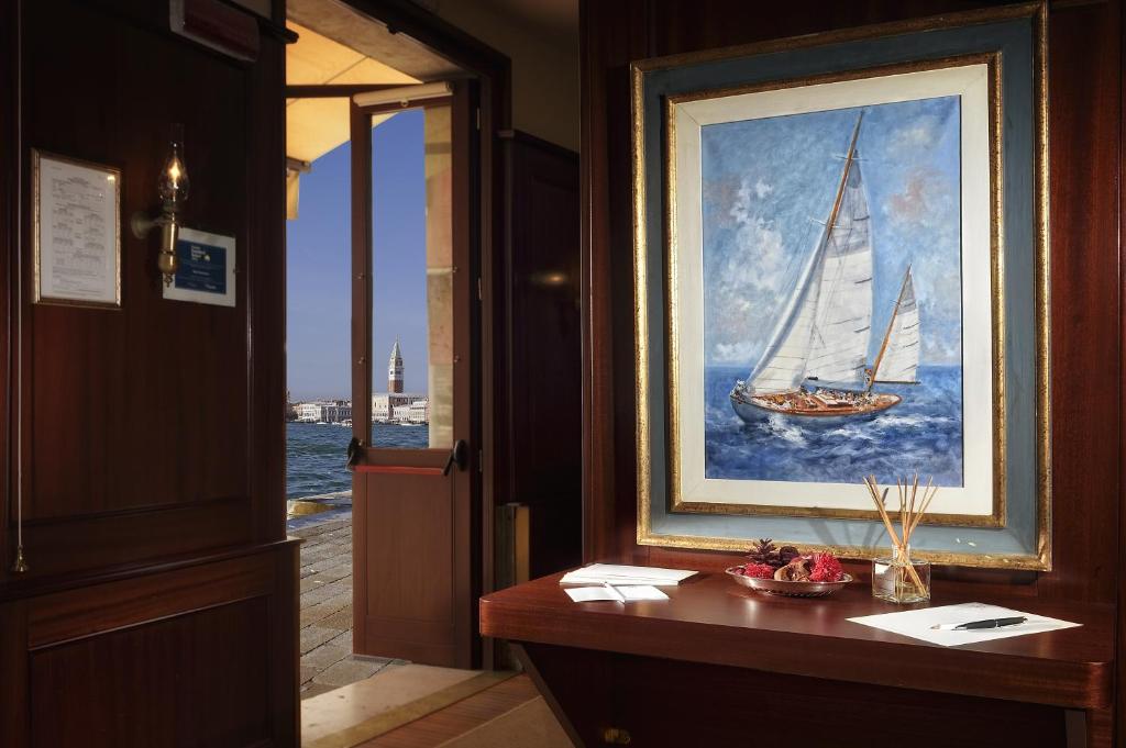 a painting of a sail boat in a painting at Hotel Bucintoro in Venice
