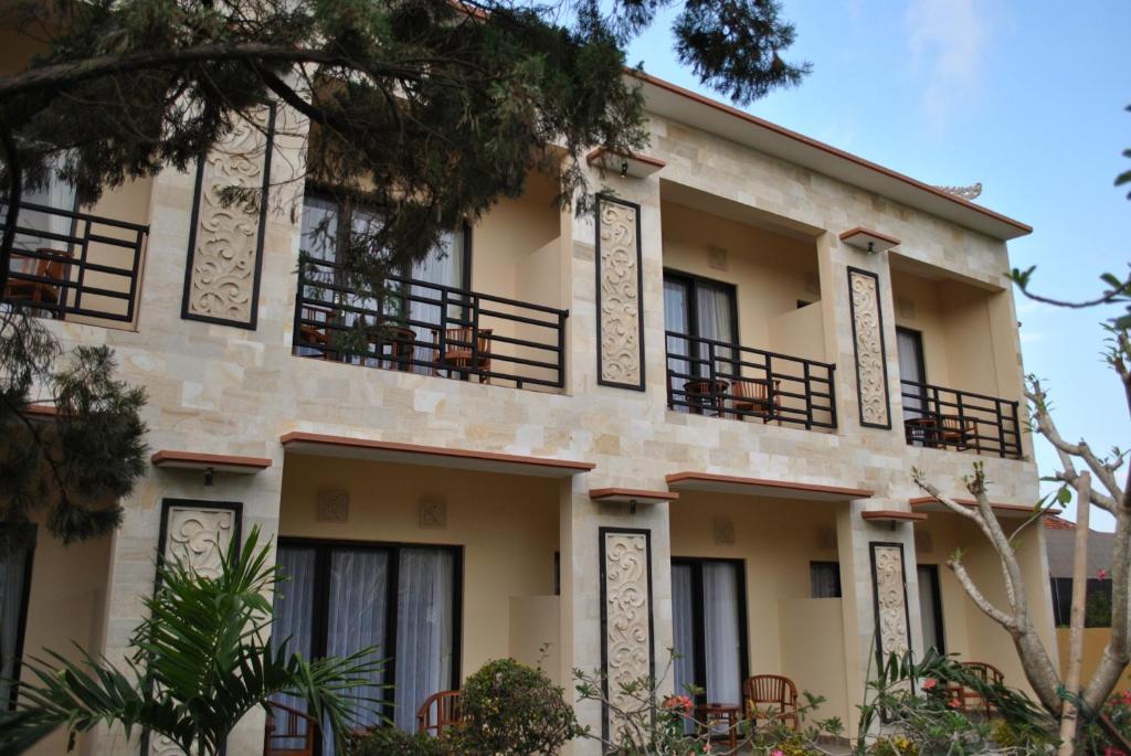 a building with balconies on the side of it at Betesda Guest House in Canggu