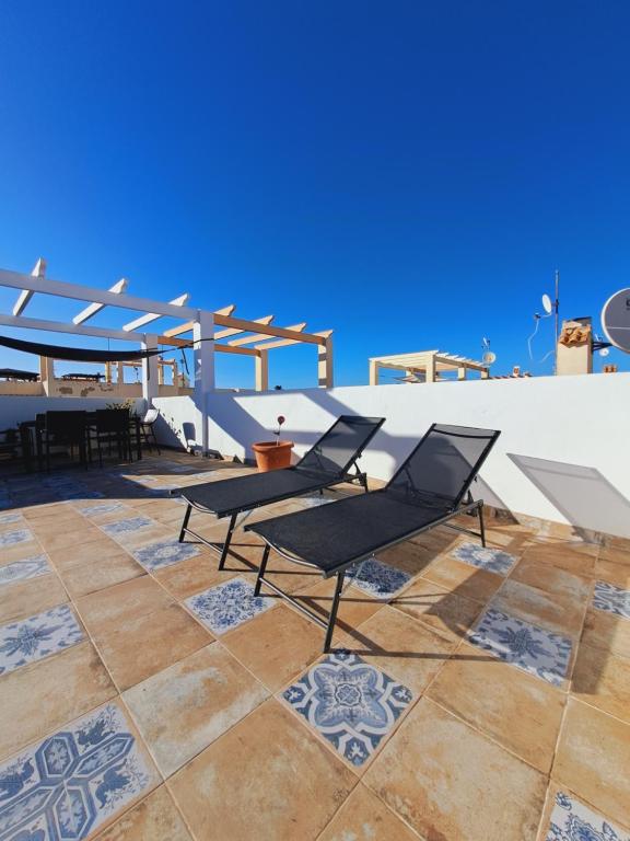 a group of chairs sitting on a patio at Casa Rosalia in Orihuela Costa