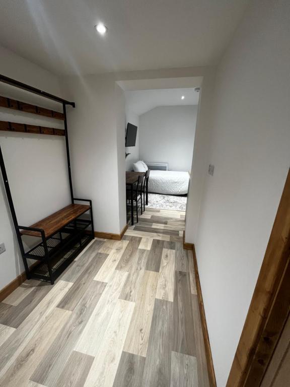 a room with a bed and a wooden floor at Small home in Llanfairpwll in Llanfairpwllgwyngyll