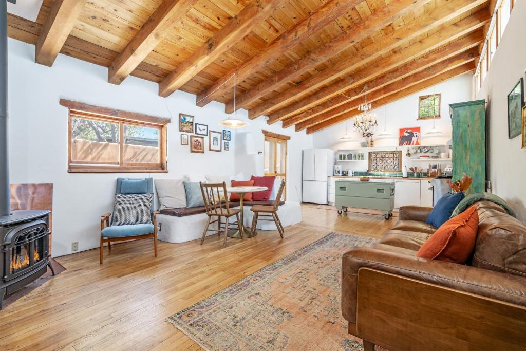 a living room with a couch and a table at Heart of Santa Fe - Adorable Hideaway - King and Queen - Walk to Everything - Fireplace - AC in Santa Fe
