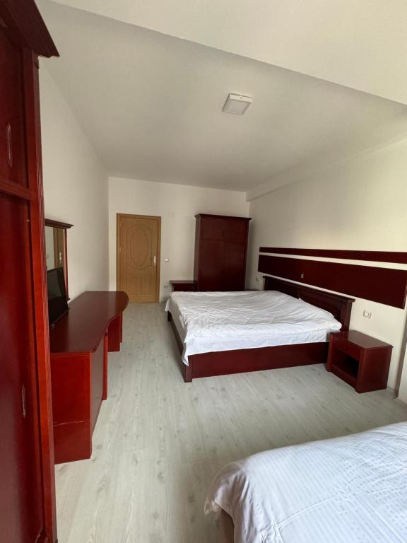 a hotel room with two beds and a desk at D&M Apartments in Struga
