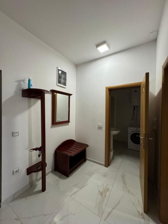 a room with a bathroom with a sink and a door at M&D Apartment in Struga