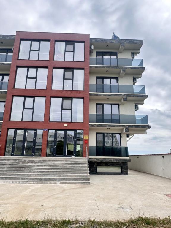 a building with a staircase in front of it at Christale Rooms in Năvodari