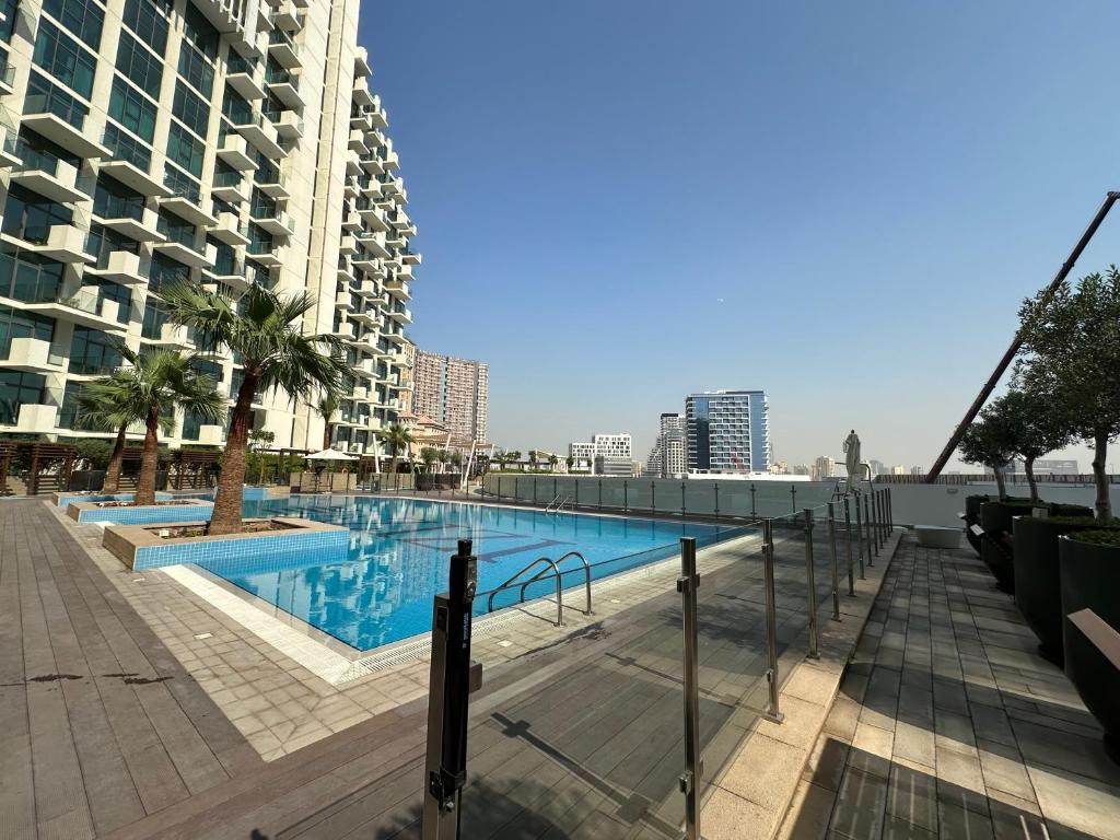 a swimming pool on the roof of a building at AshriHH/ ModernStudio in Jadaf in Dubai