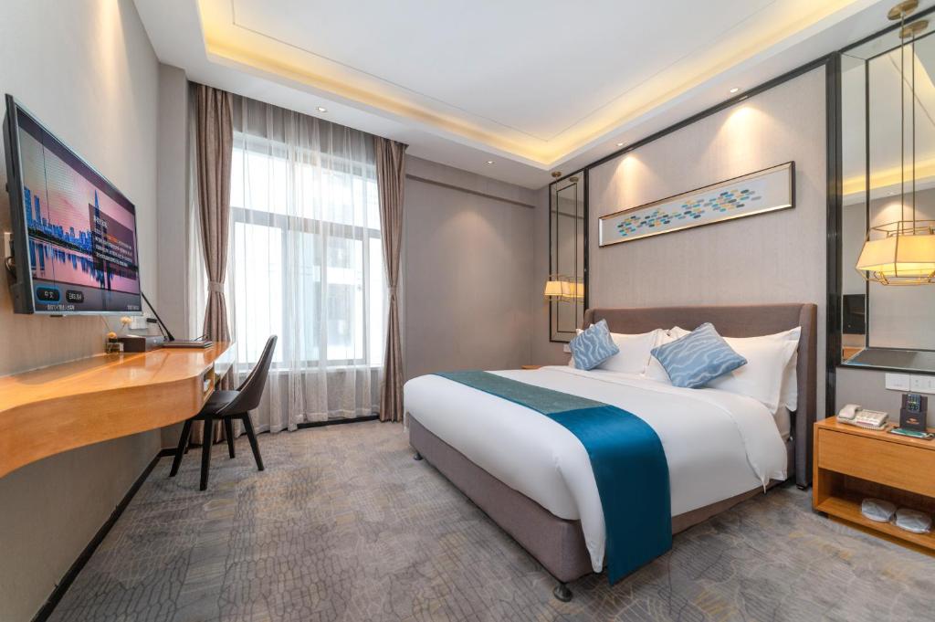 Postel nebo postele na pokoji v ubytování Sun Garden Hotel