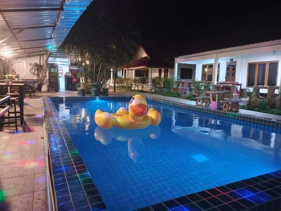a swimming pool with a rubber duck in the water at Pai Family Resort in Pai