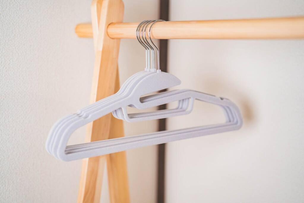 a plastic towel holder hanging from a wooden rack at New! Kamata close Haneda AP - Traditional & Hot Spring in Tokyo