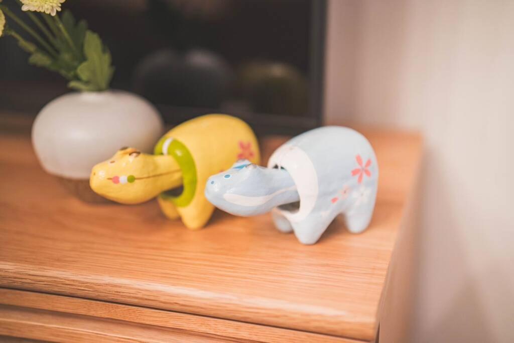 three small toy figurines sitting on a wooden shelf at New! Kamata close Haneda AP - Traditional & Hot Spring in Tokyo