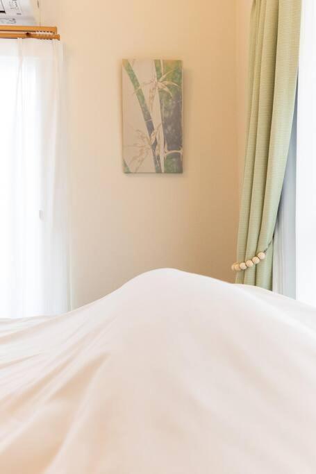 a bedroom with a white bed and a window at New! Kamata close Haneda AP - Traditional & Hot Spring in Tokyo