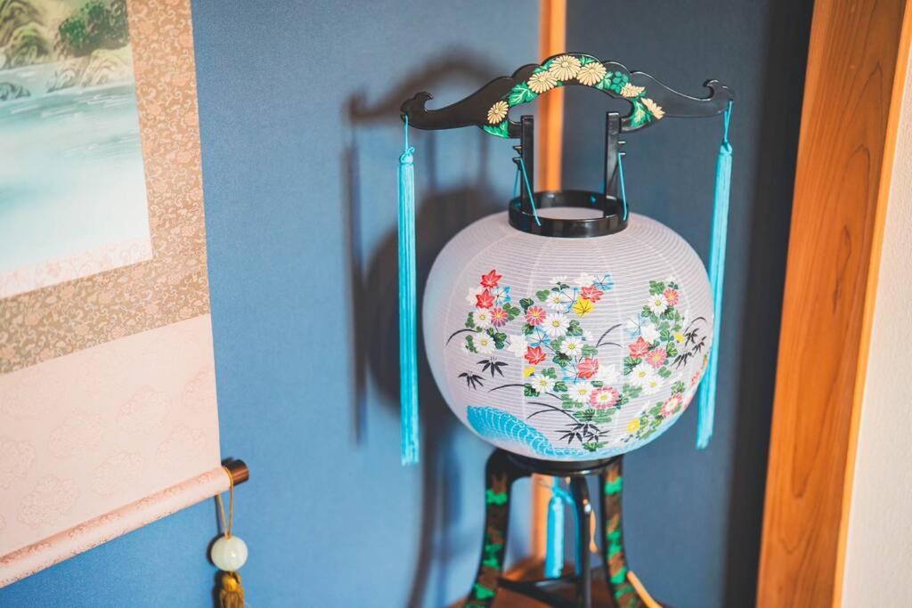 a vase with flowers on it is hanging on a wall at New! Kamata close Haneda AP - Traditional & Hot Spring in Tokyo