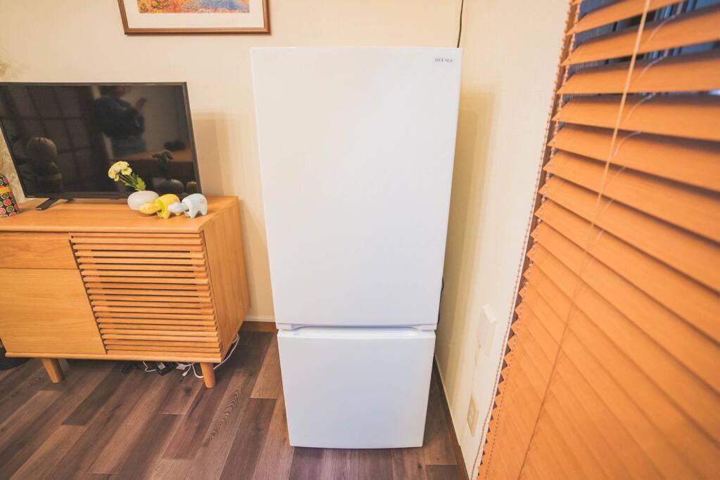 a white refrigerator in the corner of a room at New! Kamata close Haneda AP - Traditional & Hot Spring in Tokyo
