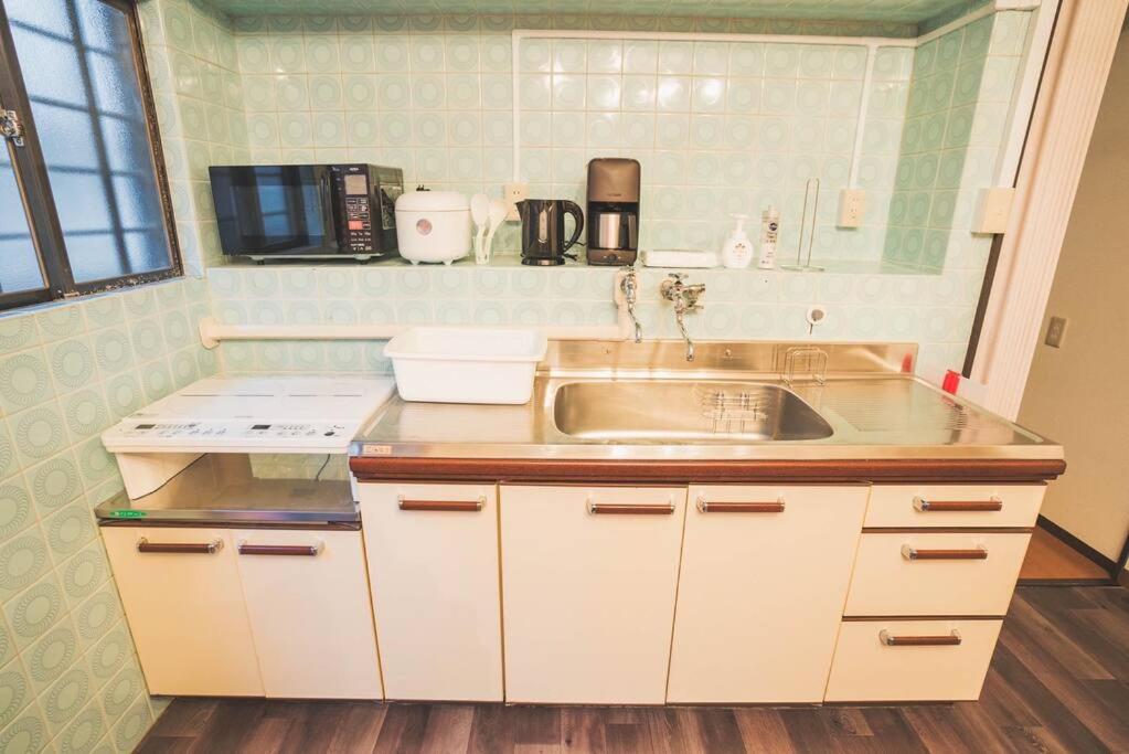 a kitchen with a sink and a counter top at New! Kamata close Haneda AP - Traditional & Hot Spring in Tokyo