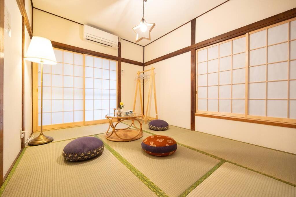 a room with three ottomans and a table at New! Kamata close Haneda AP - Traditional & Hot Spring in Tokyo