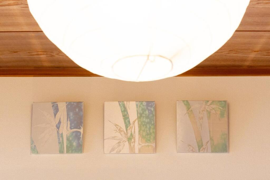 four pictures of plants on a wall with a light at New! Kamata close Haneda AP - Traditional & Hot Spring in Tokyo