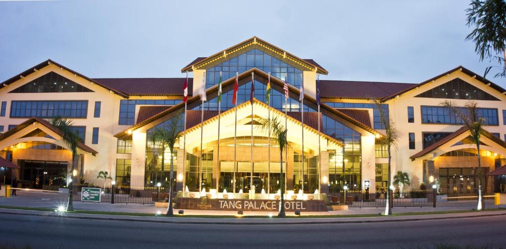 a large building on a city street at night at Tang Palace Hotel in Accra