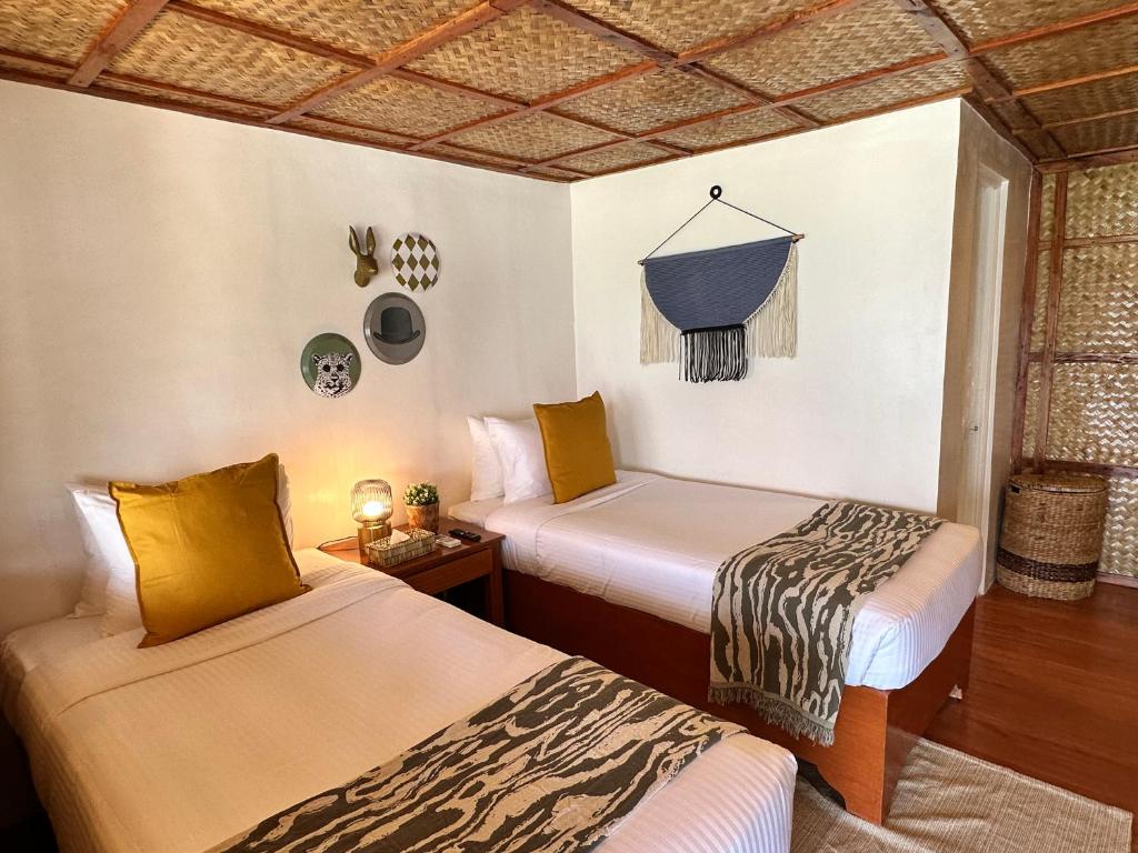 Postel nebo postele na pokoji v ubytování Beach Huts El Nido