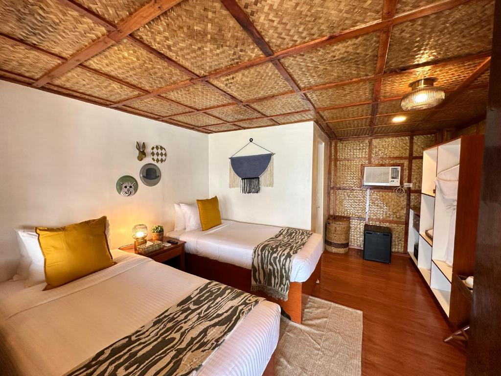 Postel nebo postele na pokoji v ubytování Beach Huts El Nido