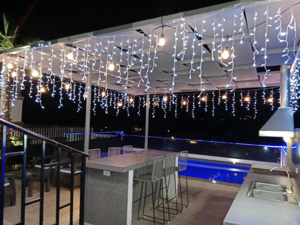 a patio with lights and a table and a pool at Alberca Caliente, Heated Pool House with the view in San Carlos