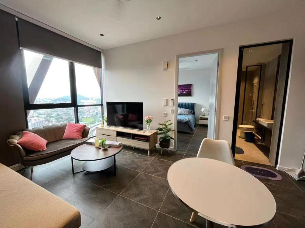 a living room with a couch and a table at Borderless Swimming Pool - Invincible Twin Towers View - Free WiFi in Kampong Gombak Utara